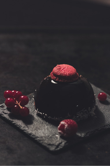 lava cake decorated with berries and red macaron